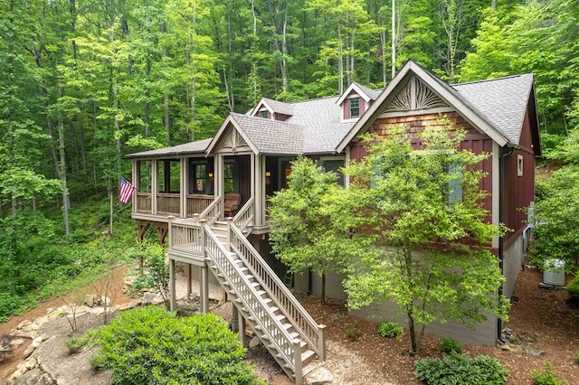 45 Boulder Creek Ln, Tuckasegee, NC 28783 - chalet / cabin featuring roof with shingles, stairway, a wooded view, and a porch