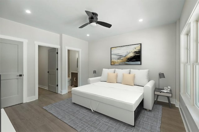 bedroom with wood finished floors, baseboards, recessed lighting, ensuite bathroom, and a ceiling fan