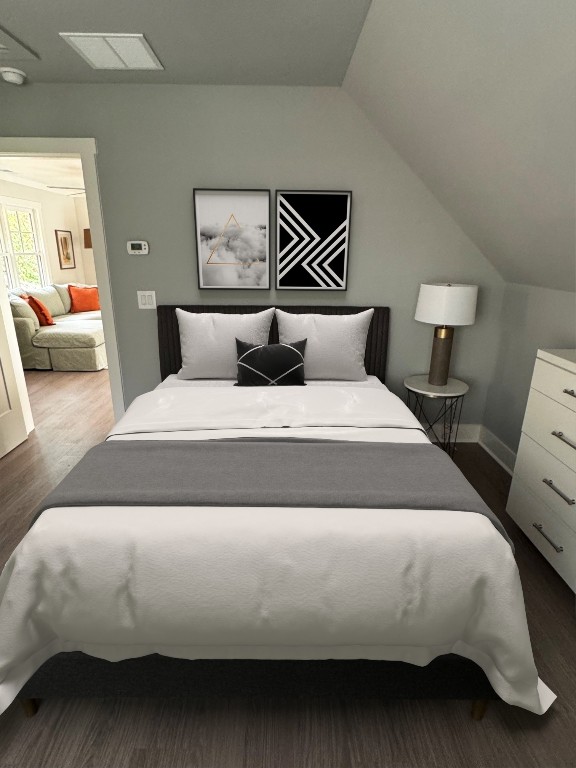 bedroom with lofted ceiling and wood finished floors