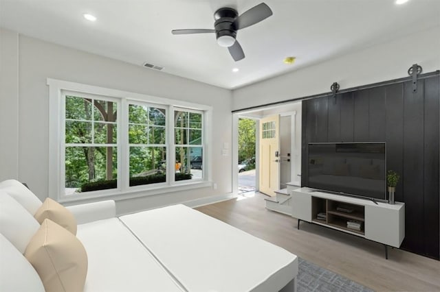 bedroom with wood finished floors, recessed lighting, access to outside, and ceiling fan