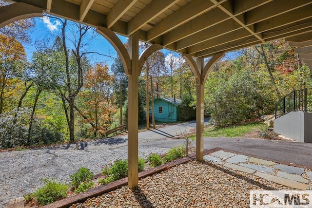 view of yard featuring a patio and an outdoor structure