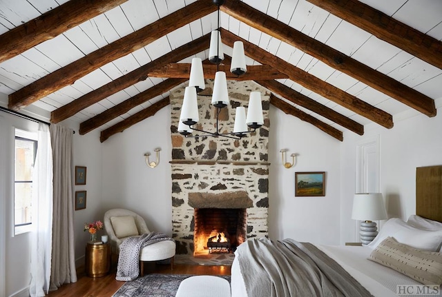 bedroom with hardwood / wood-style floors, vaulted ceiling with beams, wooden ceiling, and a fireplace