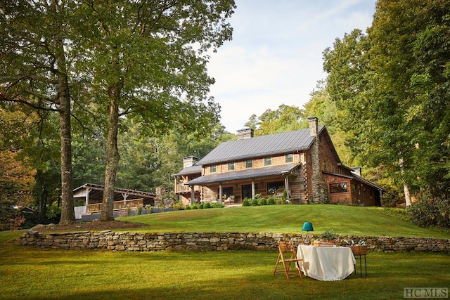 rear view of property featuring a yard