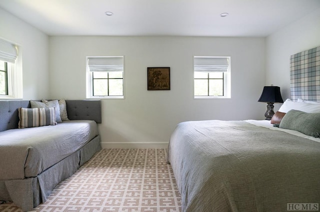 carpeted bedroom featuring multiple windows