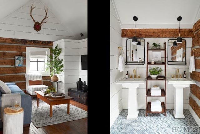 interior space with wood-type flooring, vaulted ceiling, wood walls, sink, and decorative columns