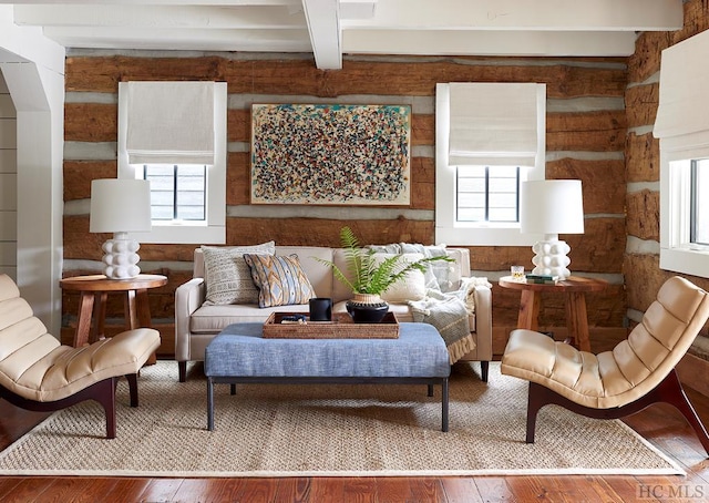 living room featuring hardwood / wood-style flooring, beamed ceiling, and a wealth of natural light