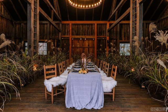 wine area with hardwood / wood-style flooring and a chandelier