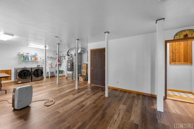 workout room with hardwood / wood-style flooring and independent washer and dryer