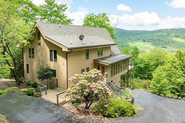 exterior space with a sunroom and a deck