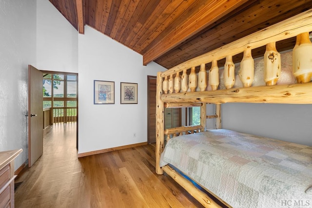 bedroom with vaulted ceiling with beams, wood ceiling, and light hardwood / wood-style flooring