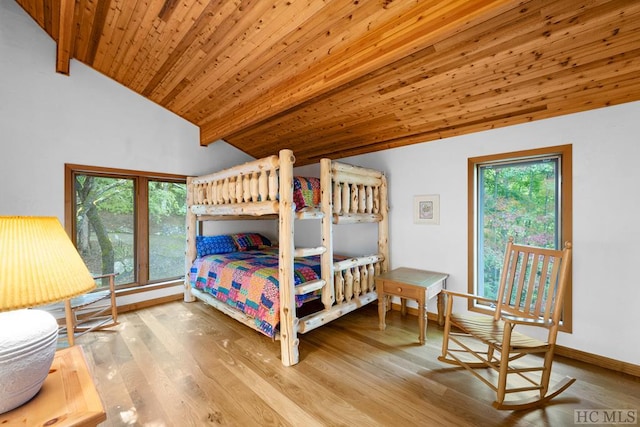 bedroom with wood ceiling, lofted ceiling with beams, and light hardwood / wood-style flooring