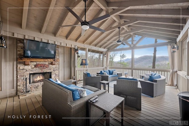 sunroom featuring an outdoor stone fireplace, wood ceiling, lofted ceiling with beams, and ceiling fan