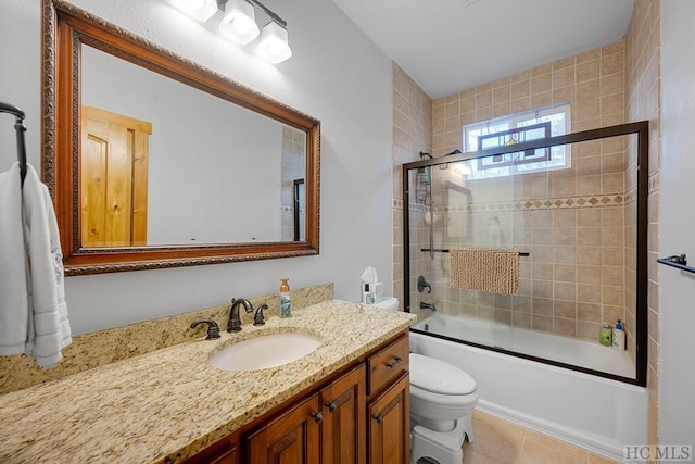 full bathroom with enclosed tub / shower combo, vanity, tile patterned flooring, and toilet