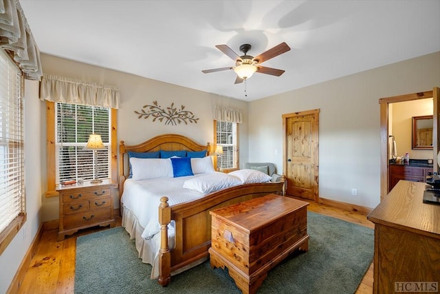 bedroom with light hardwood / wood-style floors and ceiling fan