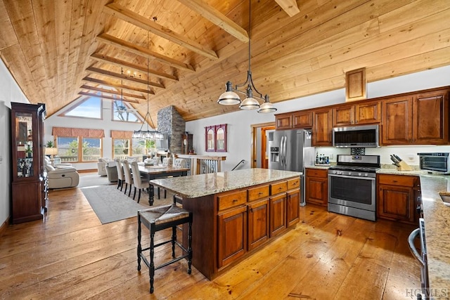 kitchen featuring hanging light fixtures, stainless steel appliances, light stone countertops, wooden ceiling, and a kitchen island