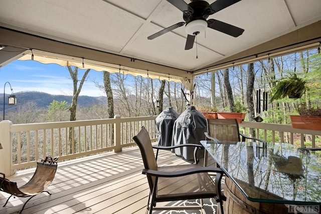 wooden terrace with a mountain view and ceiling fan