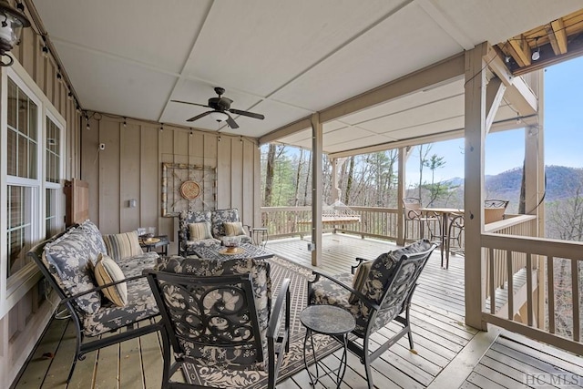 sunroom / solarium featuring plenty of natural light and ceiling fan