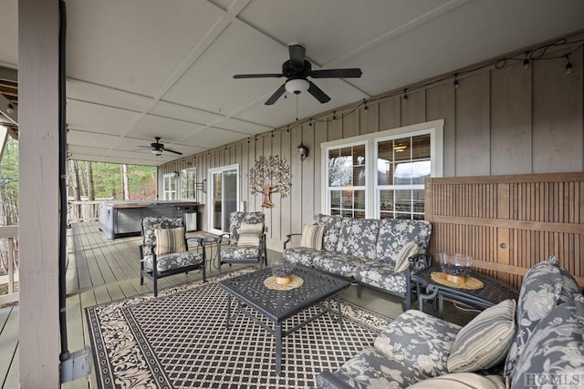 sunroom featuring ceiling fan