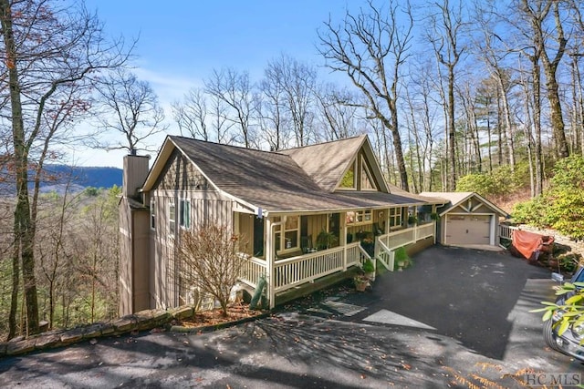 view of front of property with covered porch and a garage