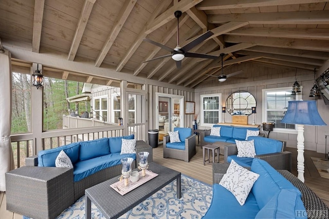 sunroom / solarium featuring ceiling fan and lofted ceiling