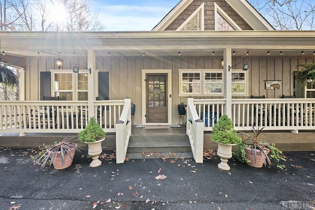 view of exterior entry with covered porch