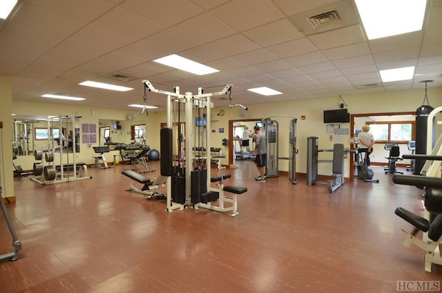 gym with a paneled ceiling