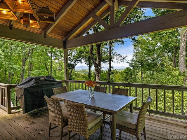 wooden deck featuring area for grilling and ceiling fan