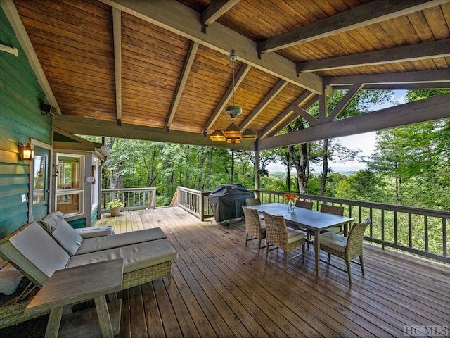 wooden terrace featuring area for grilling and ceiling fan