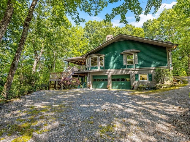 view of front facade featuring a garage and a deck