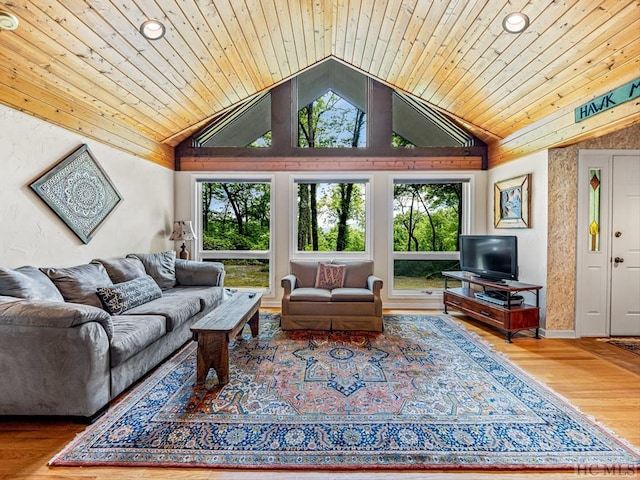 living room with hardwood / wood-style flooring, vaulted ceiling, plenty of natural light, and wooden ceiling