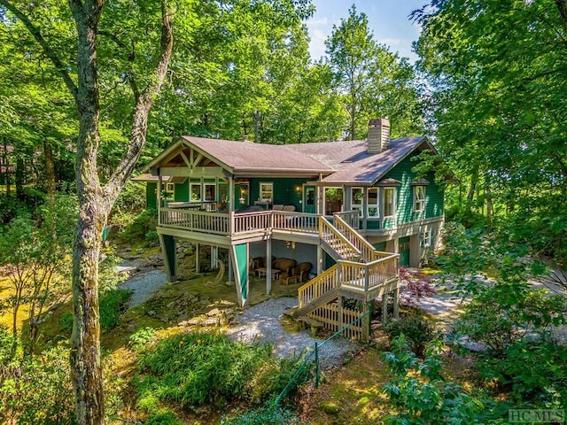 rear view of property with a wooden deck