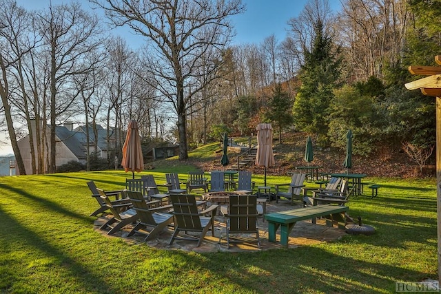 surrounding community featuring a yard and an outdoor fire pit