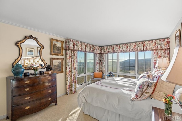 carpeted bedroom featuring a mountain view and crown molding