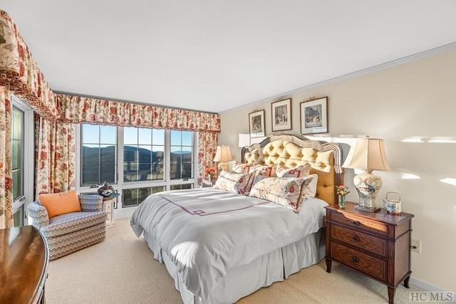 bedroom featuring light colored carpet, ornamental molding, and a mountain view