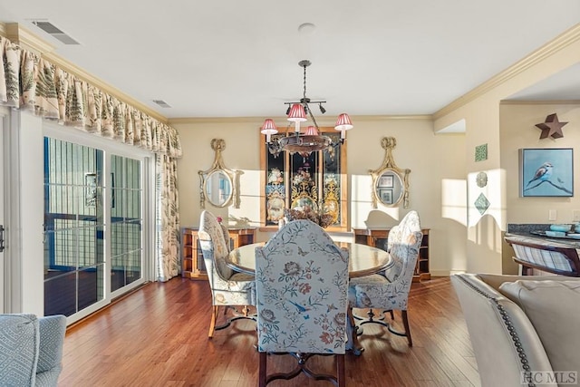 dining space featuring crown molding and wood-type flooring