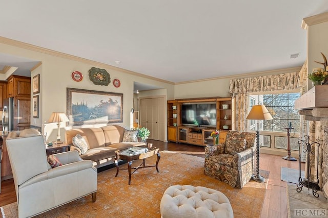 living room featuring ornamental molding and light wood-type flooring