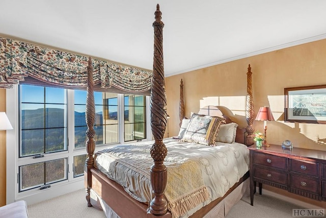 carpeted bedroom with ornamental molding and a mountain view