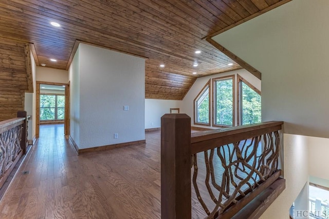 additional living space with wood ceiling, plenty of natural light, vaulted ceiling, and hardwood / wood-style flooring