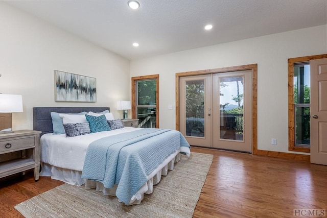 bedroom featuring hardwood / wood-style flooring, french doors, and access to outside