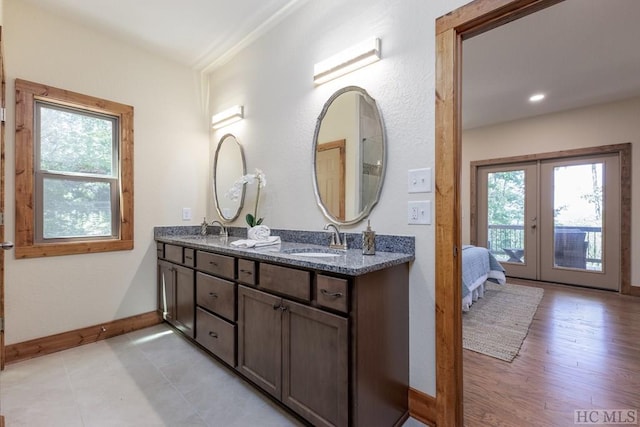 bathroom with french doors and vanity