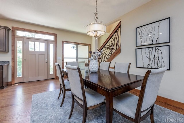 dining area featuring an inviting chandelier and light hardwood / wood-style flooring