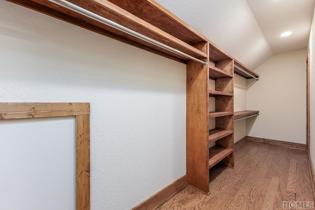 walk in closet featuring lofted ceiling and hardwood / wood-style floors