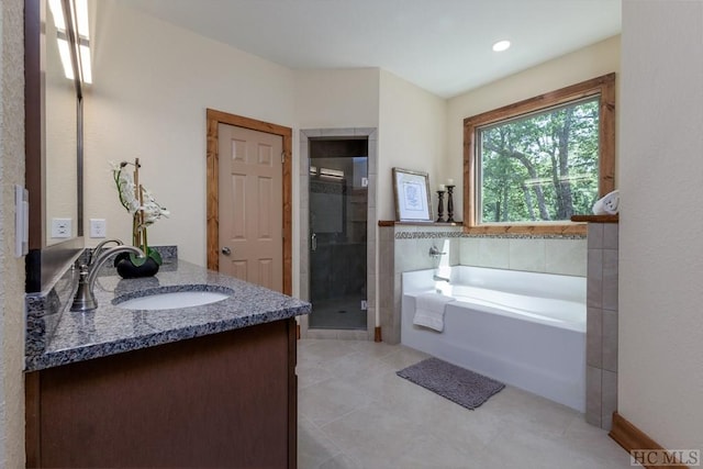 bathroom featuring vanity, shower with separate bathtub, and tile patterned floors