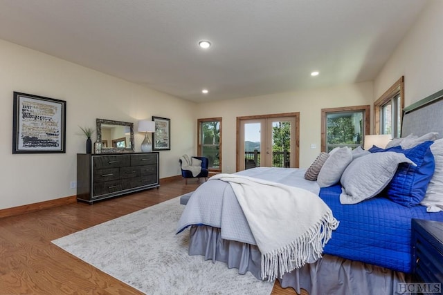 bedroom featuring dark wood-type flooring, access to outside, and french doors