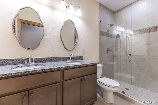 bathroom with vanity, toilet, and a shower with shower door