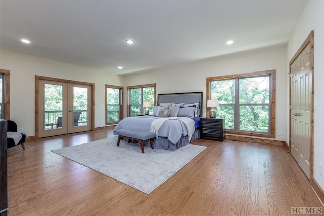 bedroom featuring french doors, access to exterior, and light hardwood / wood-style floors