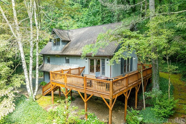 rear view of house with french doors and a wooden deck