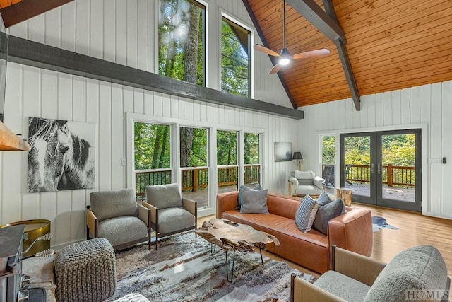 sunroom / solarium featuring french doors, vaulted ceiling with beams, ceiling fan, and wooden ceiling