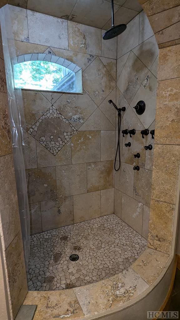 bathroom with a tile shower