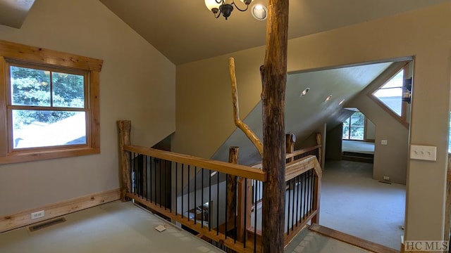 additional living space with vaulted ceiling and a chandelier